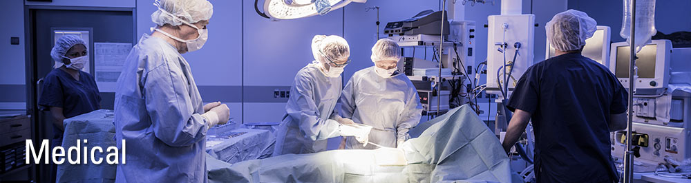 Medical professionals performing surgery in an operating room.